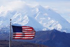 The American Flag with Mt. Denali in the background.